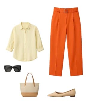 Flat lay of orange trousers, a pale yellow shirt, sunglasses, a tote and flats