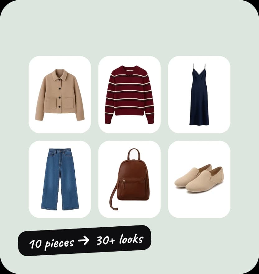 Six capsule wardrobe pieces on white tiles: camel jacket, burgundy jumper, slip dress, jeans, leather bag and loafers.